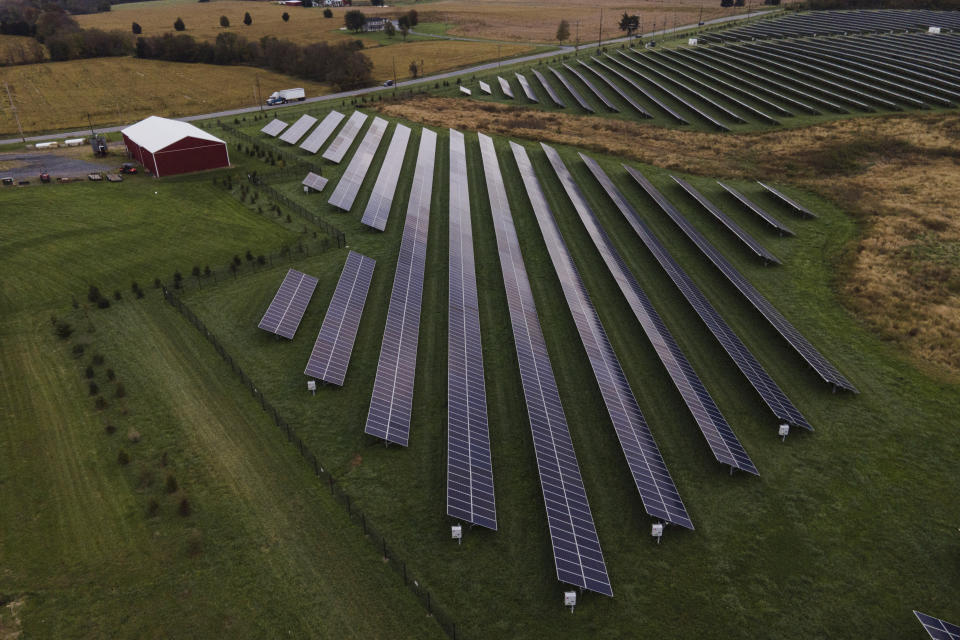 FILE - Farmland is seen with solar panels from Cypress Creek Renewables, Thursday, Oct. 28, 2021, in Thurmont, Md. A new study released on Wednesday, April 13, 2022, finds that if the nations of the world live up to their promises, future climate climate change can be limited to the weaker of two international goals. According to a study, the world is potentially on track to keep global warming at or a shade below 2 degrees Celsius (3.6 degrees Fahrenheit) hotter than pre-industrial times, a goal that once seemed out of reach. (AP Photo/Julio Cortez, File)