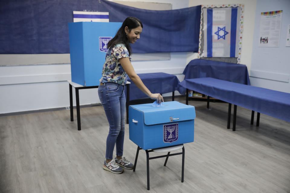 A woman votes a polling station in Rosh Haayin, Israel, Tuesday, Sept. 17, 2019. Israelis began voting Tuesday in an unprecedented repeat election that will decide whether longtime Prime Minister Benjamin Netanyahu stays in power despite a looming indictment on corruption charges. (AP Photo/Sebastian Scheiner)