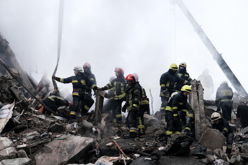 Emergency workers search the remains of a residential building that was struck by a Russian missile yesterday on Jan. 15, 2023, in Dnipro, Ukraine. (Spencer Platt / Getty Images)