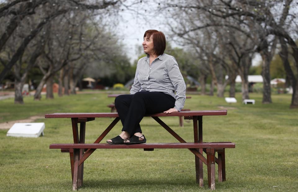 Arizona caterer Pat Christofolo, who owns Artisan by Santa Barbara Catering as well as The Farm at South Mountain, sits on a picnic table at The Farm has had business drop off due to the coronavirus shown here Wednesday, April 1, 2020, in Phoenix. The events industry, which exists to bring people together, has been hit particularly hard by fallout from COVID-19. (AP Photo/Ross D. Franklin)