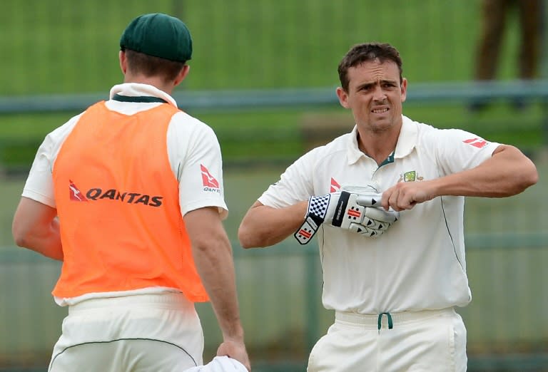 Australia's Steve O'Keeffe (R) takes a drink break during the final day of the opening Test in Pallekele on July 30, 2016