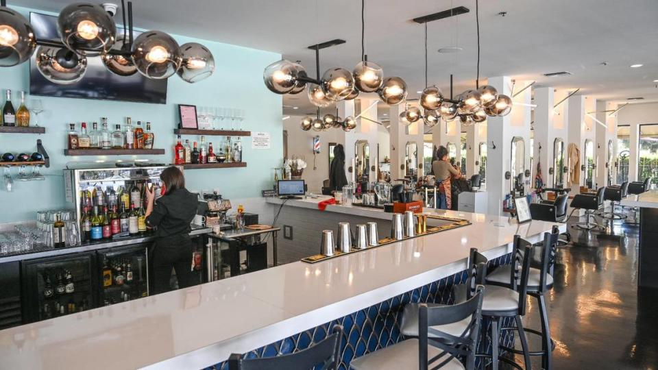 Visitors to the Genesis Bistro & 8028 Salon on Cedar and Nees are greeted with a bar to the left and hair styling stations to the right.