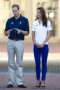 <p><em>July 26, 2012 —</em> When the Olympic Torch arrived at Buckingham Palace on its route to the Olympic Stadium, Kate wore a sporty-chic outfit of blue skinny jeans, a white polo, and her favorite pair of wedges.</p>