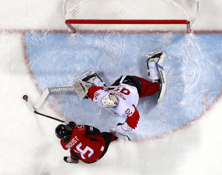 Women Preliminary Round Match - Canada v Olympic Athletes from Russia - Gangneung Hockey Centre, Gangneung, South Korea – February 11, 2018 - Melodie Daoust of Canada and goalkeeper Nadezhda Morozova, an Olympic athlete from Russia, in action. REUTERS/Brian Snyder