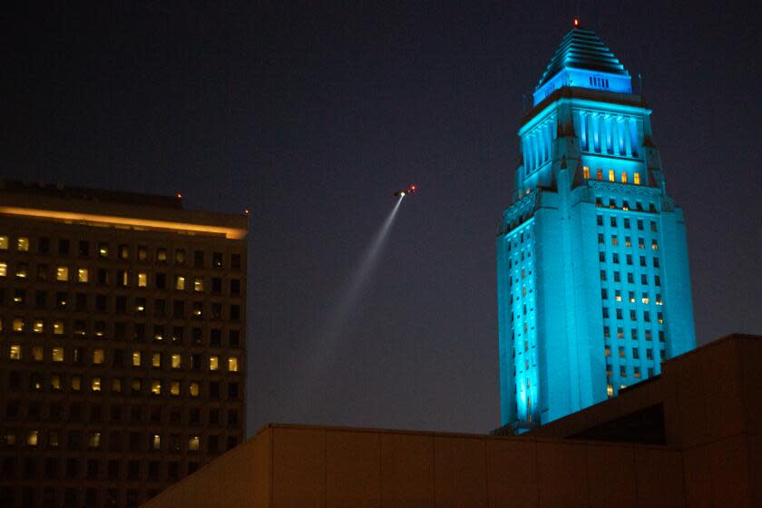 LOS ANGELES, CA - MAY 27: An LAPD helicopter hovers over a second protest forming at the LAPD headquarters after a Black Lives Matter Protest in solidarity with other national demonstrations to show outrage over the death of George Floyd in downtown Los Angeles on Wednesday, May 27, 2020 in Los Angeles, CA. (Gabriella Angotti-Jones / Los Angeles Times)