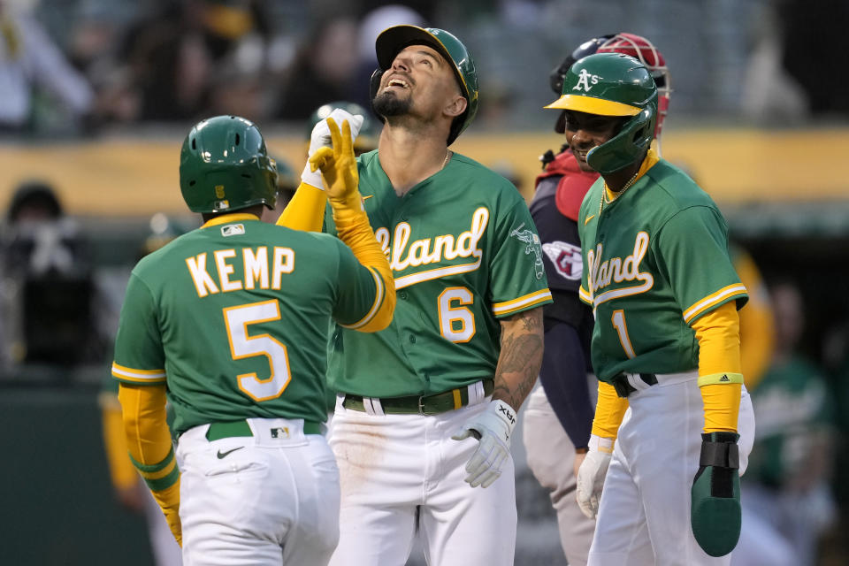 Oakland Athletics' Jace Peterson (6) celebrates after hitting a three-run home run that also scored Tony Kemp (5) and Esteury Ruiz (1) during the second inning of a baseball game against the Cleveland Guardians in Oakland, Calif., Monday, April 3, 2023. (AP Photo/Jeff Chiu)