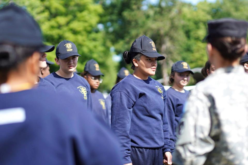 Cadet Estrella Mirroquin and other cadets stand at attention outside of the Michigan Youth Challenge Academy in Battle Creek on Monday, June 10, 2024.