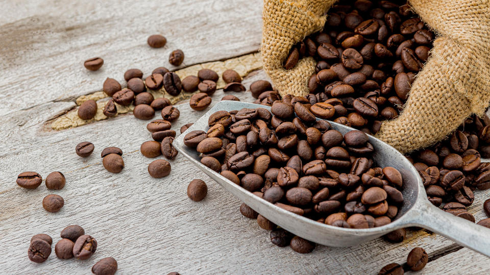 Coffee beans in a bag and a scoop