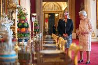 <p>The Queen supervises dessert service in the State Dining Room for an event celebrating the 200th anniversary of the birth of Queen Victoria. </p>