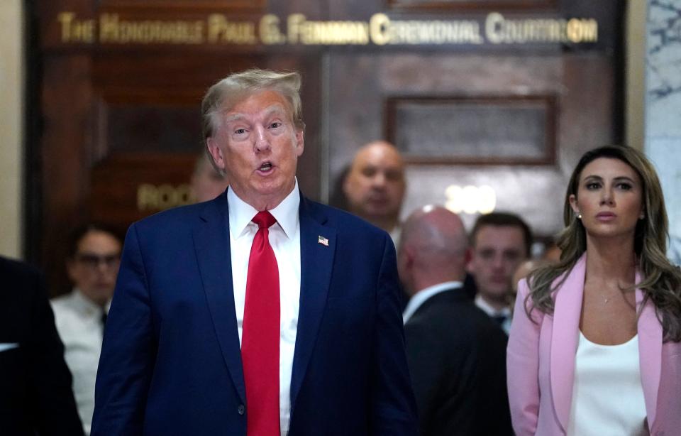 Donald Trump talks to reporters outside the New York City courtroom where his fraud trial is being held.