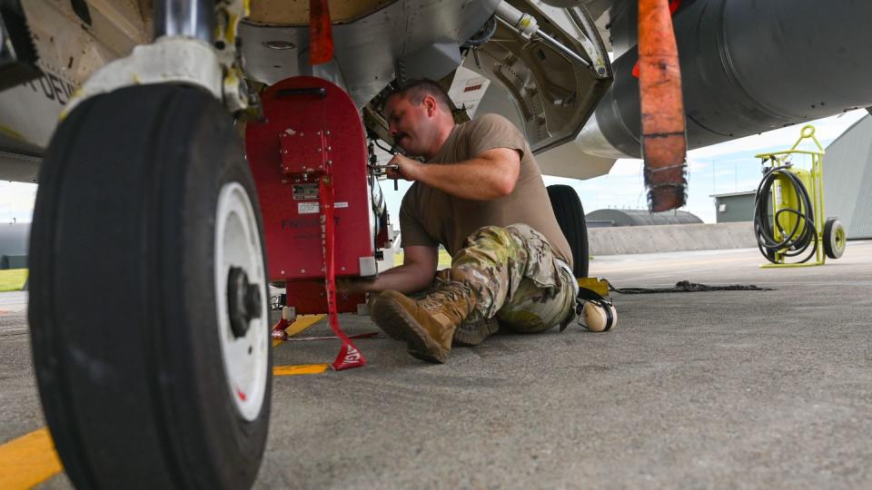 U.S. Air Force Tech. Sgt. Cody Bunderson installs an AFT Transmit Coupler AN/ALQ-184 ECM Pod on an F-16 Fighting Falcon at Misawa Air Base, Japan, in August 2023. (Staff Sgt. Ericka A. Woolever/U.S. Air Force)