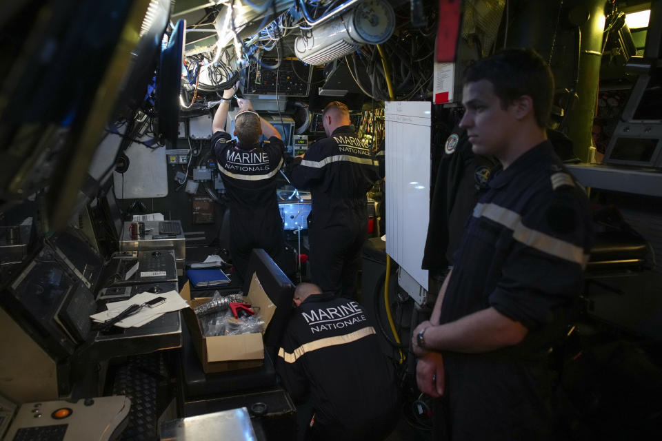 Sailors prepare a French Rubis-class submarine at the Toulon naval base in southern France, Monday, April 15, 2024. The nuclear powered submarine will be guarding France's Charles de Gaulle aircraft carrier during training exercises dubbed Neptune Strike in the Mediterranean with the 32-nation NATO military alliance. (AP Photo/Daniel Cole)