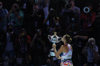 Aryna Sabalenka of Belarus kisses the Daphne Akhurst Memorial Trophy after defeating Elena Rybakina of Kazakhstan in the women's singles final during the women's singles final at the Australian Open tennis championship in Melbourne, Australia, Saturday, Jan. 28, 2023. (AP Photo/Asanka Brendon Ratnayake)