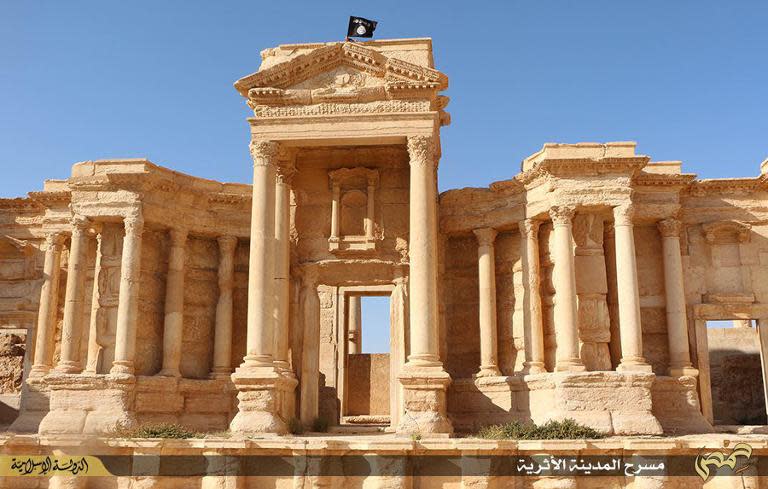 A flag of the Islamic State group is allegedly shown fluttering atop the circular wall bounding the orchestra at the Roman theatre in the ancient city of Palmyra, Syria, in this image from Jihadist media outlet Welayat Homs on May 28, 2015