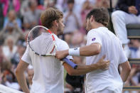 Belgium's David Goffin, left, shakes hands with Britain's Cameron Norrie after being defeated in a men's singles quarterfinal match at the Wimbledon tennis championships in London, Tuesday July 5, 2022. (AP Photo/Kirsty Wigglesworth)