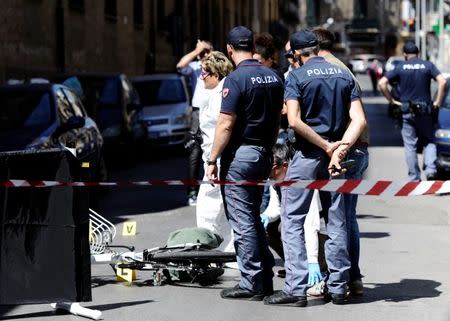 Italian police officers stand on the site where mafia boss Giuseppe Dainotti was shot to death while riding his bicycle in Palermo, Italy May 22, 2017. Picture taken May 22, 2017. REUTERS/Guglielmo Mangiapane NO RESALES. NO ARCHIVES