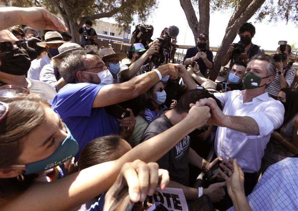 Gov. Gavin Newsom greets a crowd of supporters