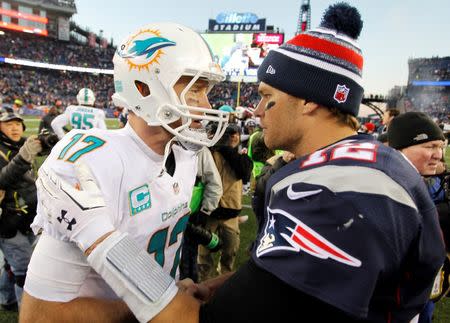 Dec 14, 2014; Foxborough, MA, USA; Miami Dolphins quarterback Ryan Tannehill (17) shakes hands with New England Patriots quarterback Tom Brady (12) after thier game at Gillette Stadium. The Patriots won 41-13. Mandatory Credit: Stew Milne-USA TODAY Sports