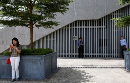 People play "Pokemon Go" in front of the "Lennon Wall" named by protestors during Occupy Central pro-democracy movement outside the government headquarters after the augmented reality mobile game launched in the city in Hong Kong, China, July 26, 2016. REUTERS/Bobby Yip