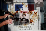 Environmental activists block the entrance of the Ministry of Ecology, Energy and Sustainable Development during a "civil disobedience action" to urge world leaders to act against climate change, in La Defense near Paris, France, April 19, 2019. The slogan reads " Macron, President of polluters". REUTERS/Benoit Tessier