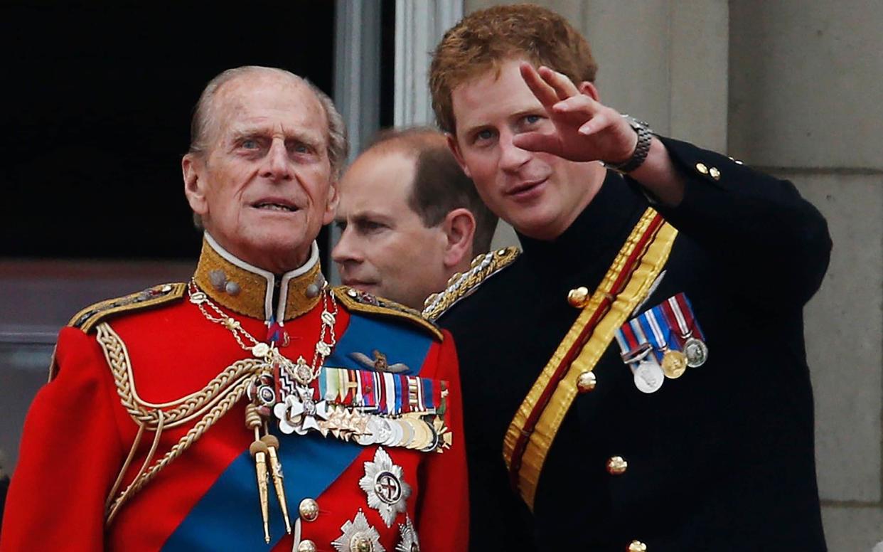 Prince Harry, pictured with Prince Philip on the balcony of Buckingham Palace in June 2014 -  Lefteris Pitarakis/AP