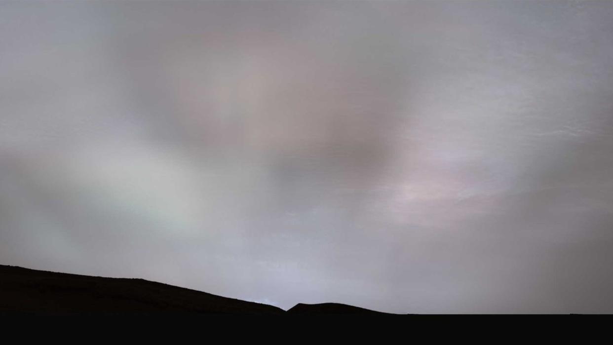  beams of light can be seen stretched across a cloudy sky over mars 