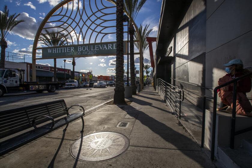 EAST LOS ANGELES, CA - March 11: A pedestrian walks by the sundial plaque honoring Cesar Chavez, who was a Latino American civil rights activist, labor leader, community organizer and businessman, at the Latino Walk of Fame on Whittier Blvd. in East Los Angeles Thursday, March 11, 2021. Chavez' sundial plaque was the first on the Walk of Fame, a collection of 10 sundial plaques on Whittier Boulevard that have fallen into disrepair. Eventually, more than 200 plaques will line the boulevard that cuts through East Los Angeles, an unincorporated area of the Eastside. It was inaugurated on April 30, 1997 by the Whittier Blvd. Merchant Assoc of East Los Angeles. (Allen J. Schaben / Los Angeles Times)