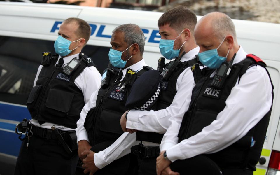 Police officers pay their respects at the custody centre where a fellow officer was shot dead - Reuters