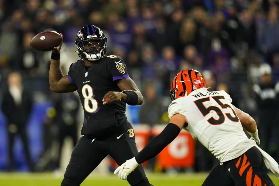 Baltimore Ravens quarterback Lamar Jackson passes the ball over Cincinnati Bengals' Logan Wilson during the second half of an NFL football game, Sunday, Oct. 9, 2022, in Baltimore. (AP Photo/Julio Cortez)