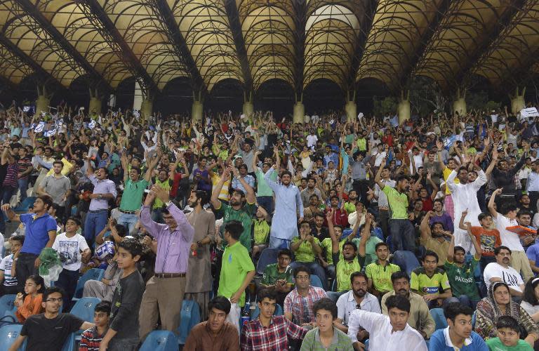 Pakistani spectators cheer their team as they attend the first International T20 cricket match between Pakistan and Zimbabwe cricket teams in Lahore on May 22, 2015