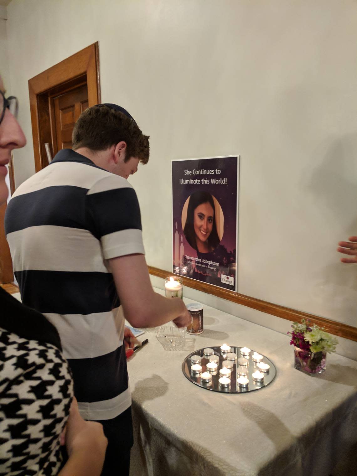 McKenzi Norris lights a Shabbat candle in honor of Samantha Josephson, whom police say was murdered last week after getting in a car she thought was her Uber.