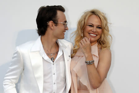 72nd Cannes Film Festival - The amfAR's Cinema Against AIDS 2019 event - Antibes, France, May 23, 2019. Pamela Anderson poses with Brandon Lee. REUTERS/Eric Gaillard