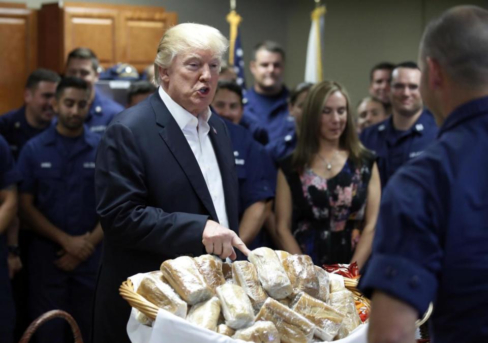 Donald Trump prepares to hand out sandwiches to members of the US Coast Guard (AP)