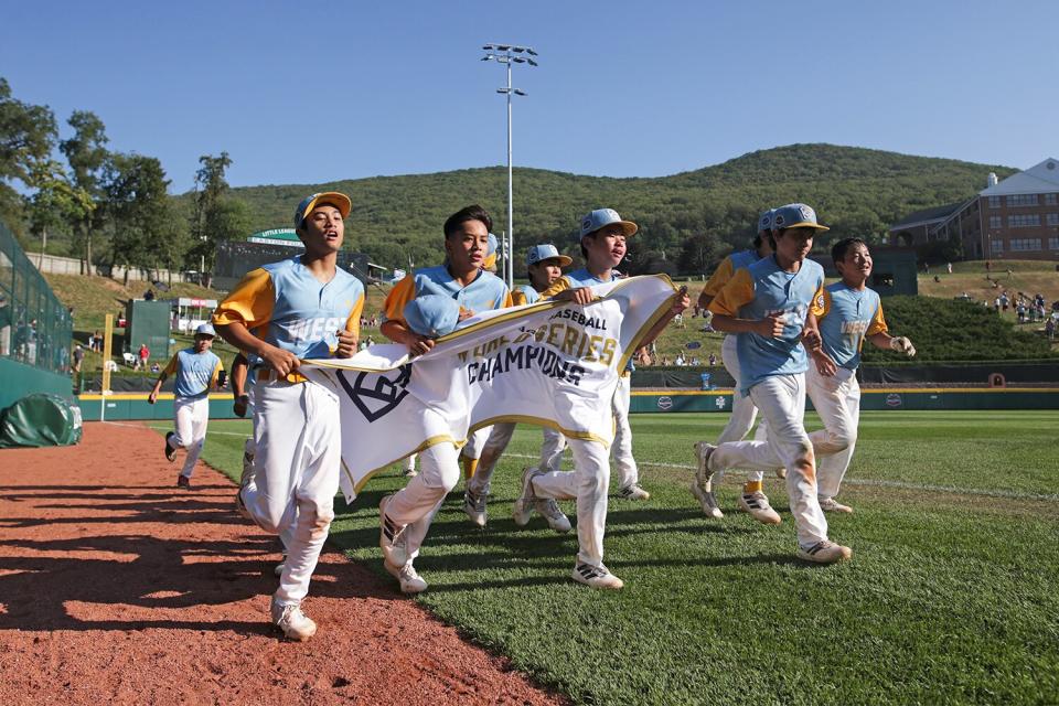 Players from the West Region team from Honolulu, Hawaii celebrate after winning against the Caribbean Region team from Willemstad, Curacao 13-3 at Little League International Complex on August 28, 2022 in South Williamsport, Pennsylvania.