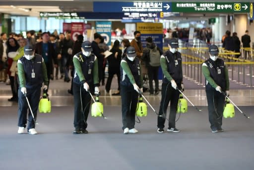 Cleaners spray disinfectant at Seoul's Incheon international airport after South Korea confirmed its first case of the SARS-like virus