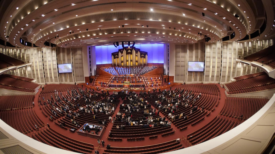 People attend The Church of Jesus Christ of Latter-day Saints' twice-annual church conference Saturday, Oct. 2, 2021, in Salt Lake City. The Utah-based faith has repeatedly encouraged its 16 million members worldwide to limit the spread by getting vaccines and wearing masks. The conference is taking place again without full attendance due to the pandemic. For the first time in two years, though, leaders were back at the faith's 20,000-seat conference center, with several hundred people watching in person. (AP Photo/Rick Bowmer)