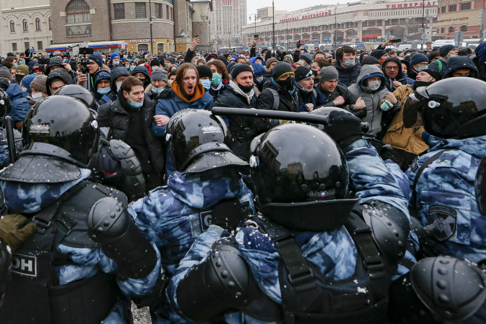 People clash with police during a protest against the jailing of opposition leader Alexei Navalny in Moscow, Russia, Sunday, Jan. 31, 2021. Thousands of people took to the streets Sunday across Russia to demand the release of jailed opposition leader Alexei Navalny, keeping up the wave of nationwide protests that have rattled the Kremlin. Hundreds were detained by police. (AP Photo/Alexander Zemlianichenko)