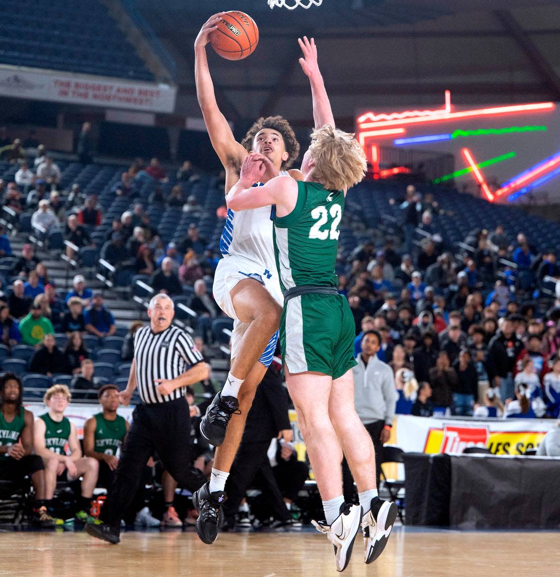 Federal Way’s Dace Pleasant powers to the basket against Skyline defender Atticus Boba during their state quarterfinal game at the WIAA state basketball tournament in the Tacoma Dome in Tacoma, Washington, on Wednesday, March 1, 2023. Federal Way won the game, 69-53.