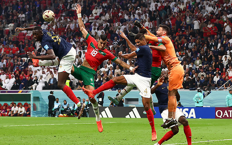 Hugo Lloris (right) of France punches the ball clear under pressure from Jawad El Yamiq of Morocco during the 2022 FIFA World Cup semifinal match at Al Bayt Stadium in Al Khor, Qatar, on Dec. 14. <em>Chris Brunskill/UPI Photo</em>