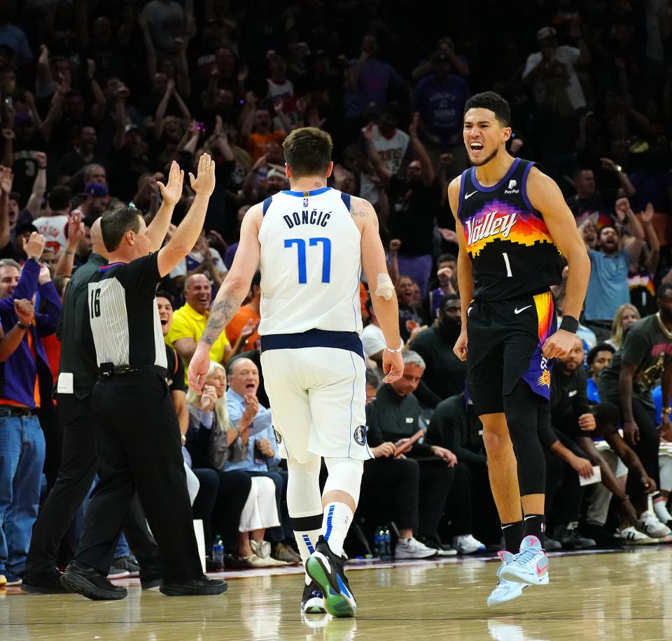 May 10, 2022; Phoenix, Arizona; USA; Suns guard Devin Booker (1) celebrates a three-pointer against the Mavericks Luka Doncic during game 5 of the second round of the Western Conference Playoffs.