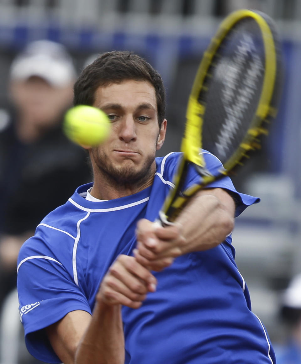 Britain's James Ward returns a shot to Sam Querrey, of the United States, during a Davis Cup tennis match Friday, Jan. 31, 2014, in San Diego. (AP Photo/Lenny Ignelzi)