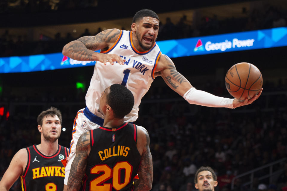 Atlanta Hawks forward John Collins (20) fouls New York Knicks forward Obi Toppin (1) during the second half of an NBA basketball game Saturday, Nov. 27, 2021, in Atlanta. (AP Photo/Hakim Wright Sr.)