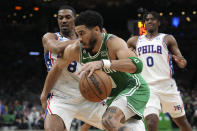 Boston Celtics forward Jayson Tatum, center, drives toward the basket past Philadelphia 76ers guards De'Anthony Melton (8) and Tyrese Maxey (0) during the second half of Game 7 in the NBA basketball Eastern Conference semifinal playoff series, Sunday, May 14, 2023, in Boston. (AP Photo/Steven Senne)