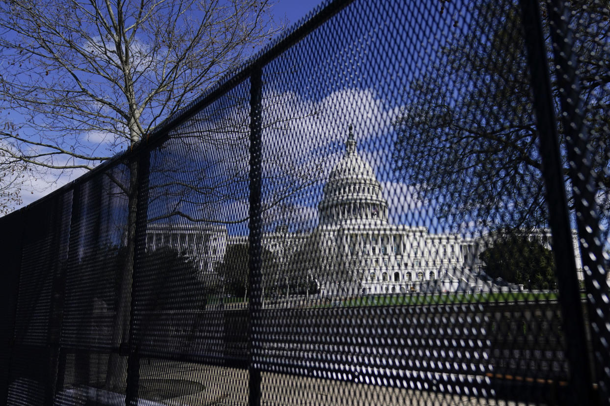 FILE - In this April 2, 2021, file photo, the U.S. Capitol is seen behind security fencing on Capitol Hill in Washington. Law enforcement concerned by the prospect for violence at a rally in the nation’s Capitol next week are planning to reinstall protective fencing that surrounded the U.S. Capitol for months after the Jan. 6 insurrection there, according to a person familiar with the discussions.  (AP Photo/Carolyn Kaster, File)