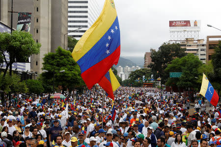 Demonstrators hold Venezuelan flags while rallying against Venezuela's President Nicolas Maduro in Caracas, Venezuela May 1, 2017. REUTERS/Carlos Garcia Rawlins