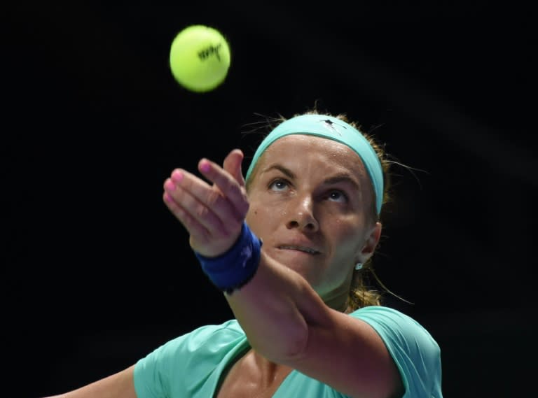 Svetlana Kuznetsova of Russia serves against Agnieszka Radwanska of Poland during their women's singles match at the WTA Finals tennis tournament in Singapore on October 24, 2016