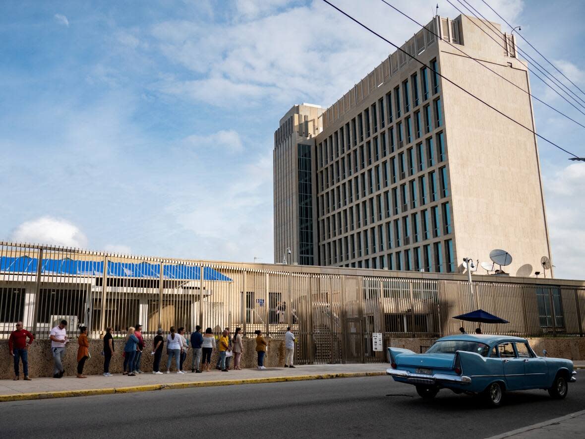 A photo taken last month shows an external view of the U.S. embassy in Havana. A line of people were waiting to enter. (Yamil Lage/AFP/Getty Images - image credit)