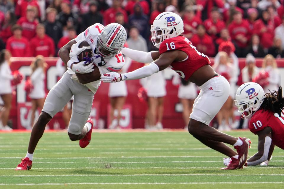 Nov 4, 2023; Piscataway, New Jersey, USA; Ohio State Buckeyes wide receiver Carnell Tate (17) runs past Rutgers Scarlet Knights defensive back Max Melton (16) after making a catch during the second half of the NCAA football game at SHI Stadium. Ohio State won 35-16.