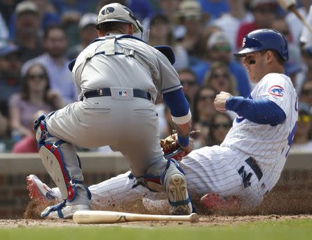 Jun 20, 2018; Chicago, IL, USA; Chicago Cubs first baseman Anthony Rizzo (44) is tagged out at home plate by Los Angeles Dodgers catcher Yasmani Grandal (9) during the eighth inning at Wrigley Field. Mandatory Credit: Jim Young-USA TODAY Sports