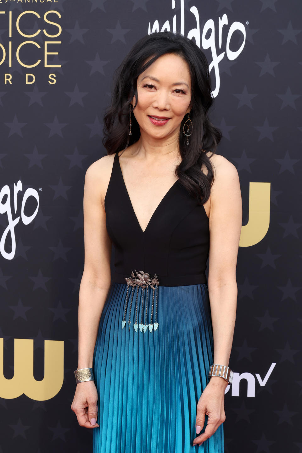 Unknown woman on the Critics Choice Awards red carpet in a sleeveless dress with a black top and a blue gradient skirt